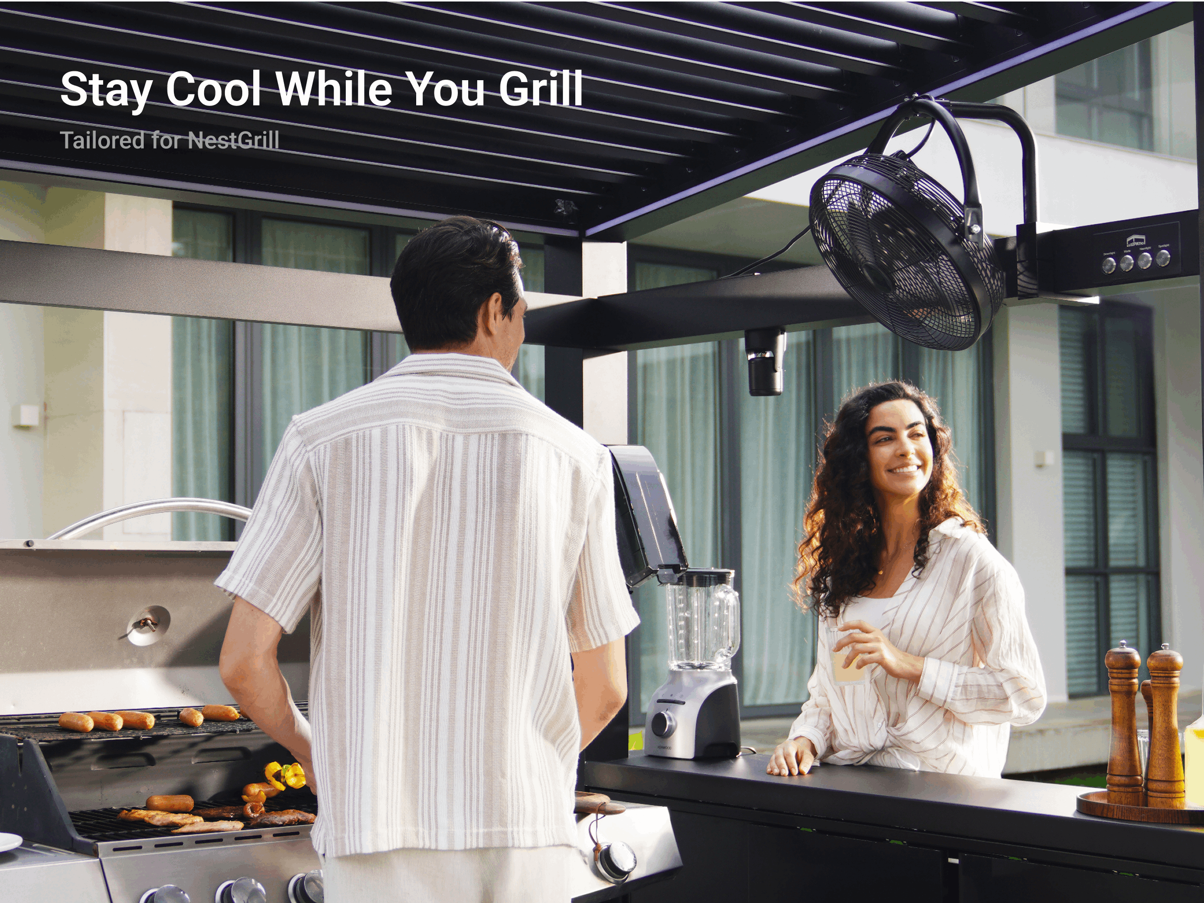 Black NestGrill grill fan keeping people cool during an outdoor barbecue in a comfortable backyard patio setting..