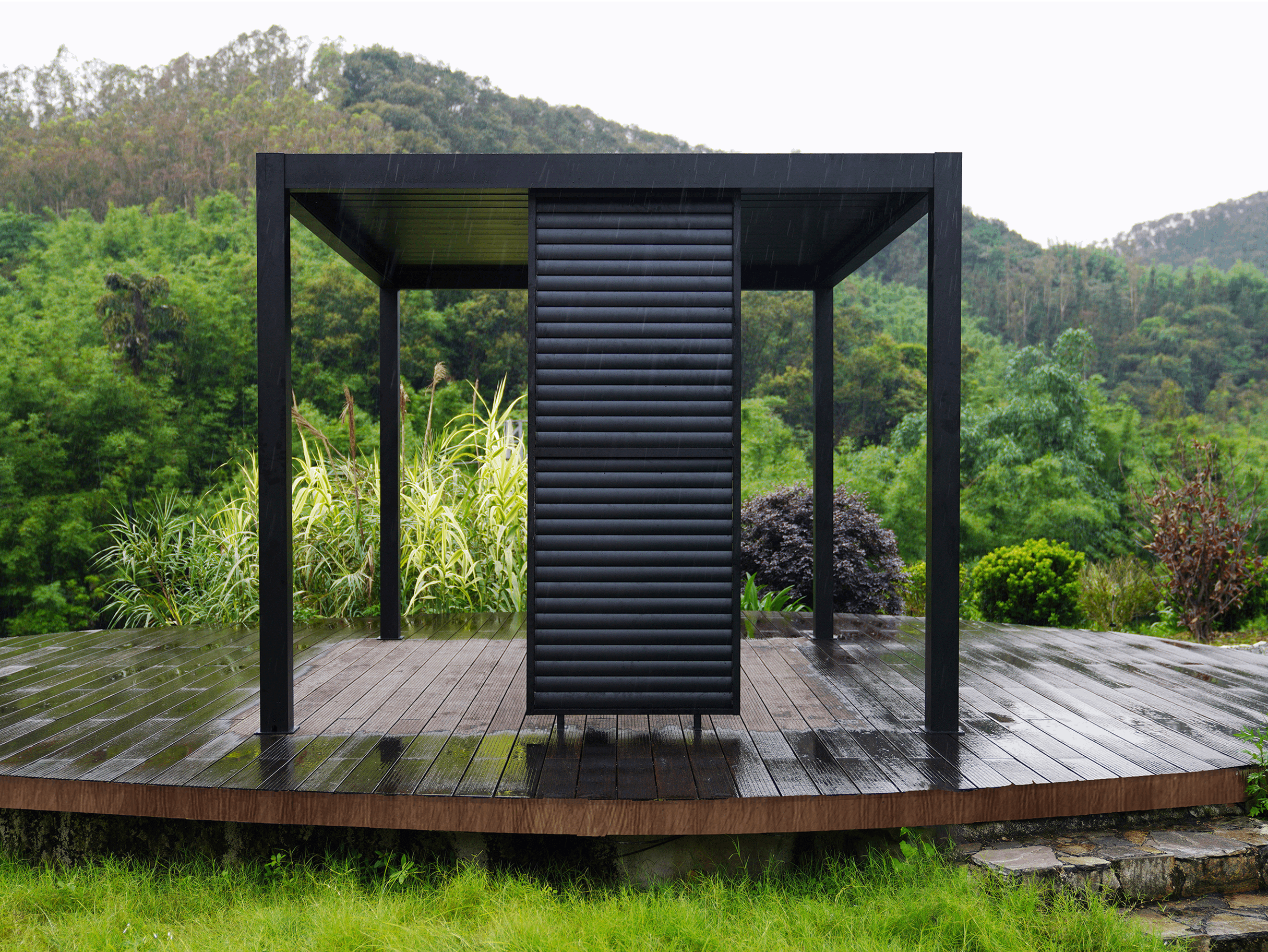 Black aluminum slat wall for Louvre 5 pergola providing privacy and shade in modern outdoor living space.